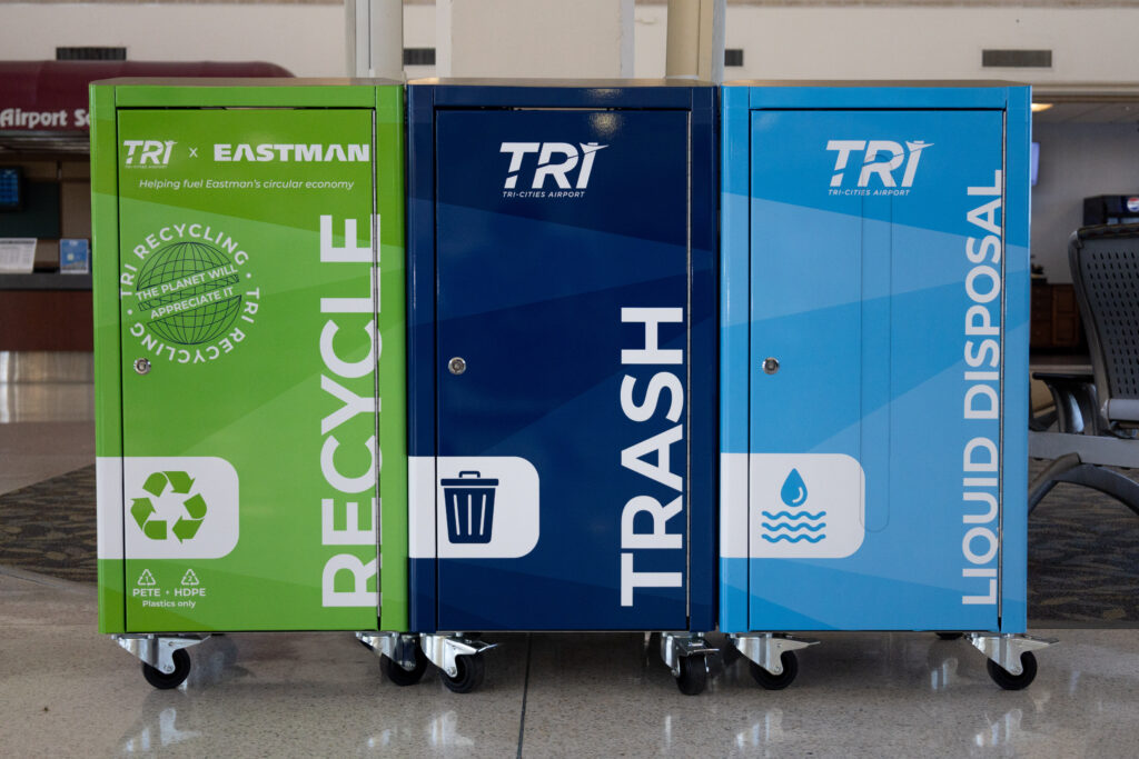 An image of three colorful garbage and recycling receptacles. 